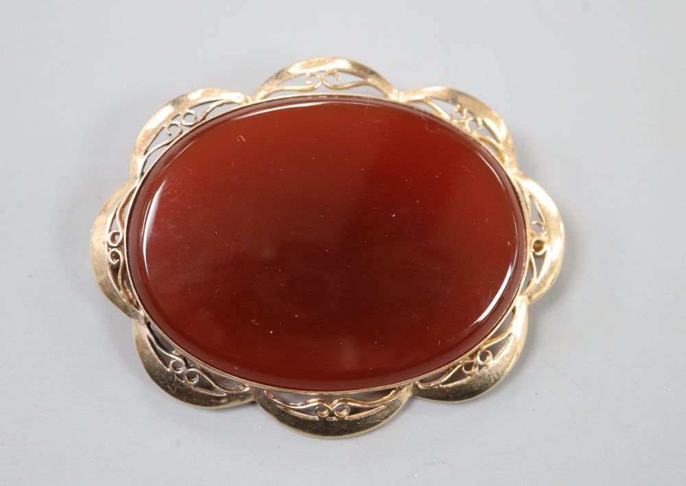 A modern 9ct gold and carnelian set oval brooch, 59mm, gross 24.9 grams.